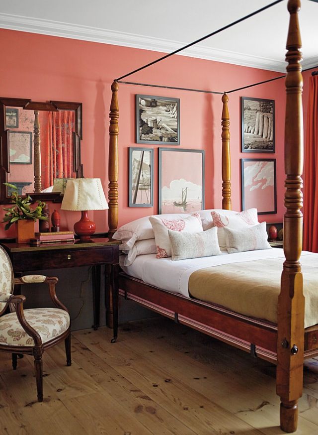 Coral bedroom wall with solid wood furniture